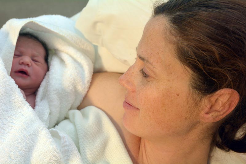 Why Hypnobirthing? Relaxed mother and newborn baby in towel